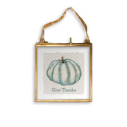 French Graffiti - Blue Pumpkin: Natural Guest Towel features a small brass-framed glass picture with a teal watercolor pumpkin and “Give Thanks” text, perfect for Thanksgiving décor.
