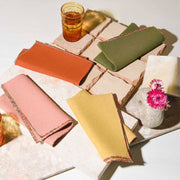 ATELIER SAUCIER - The Santa Fe Linen Napkins, set of 4, displayed on a table with glasses, showcasing premium reclaimed fabric in a kitchen setting.