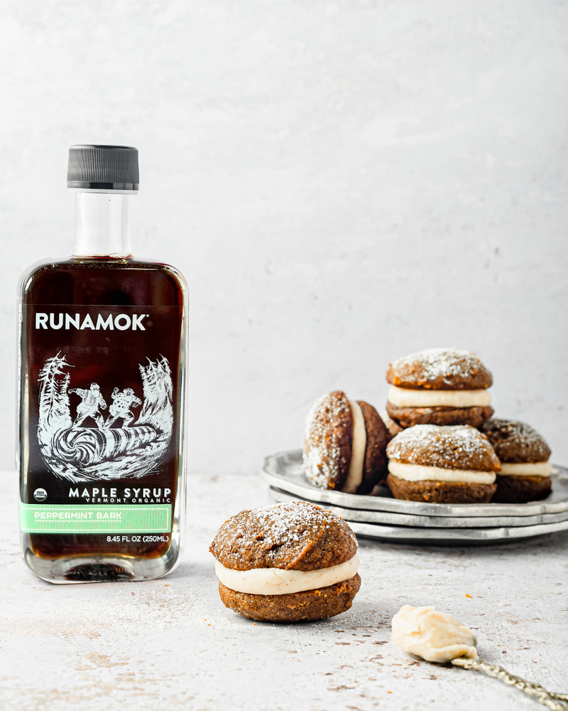 Runamok - Peppermint Bark Organic Maple Syrup 250ml bottle with whoopie pies and frosting, highlighting a unique holiday syrup flavor with mint, cocoa, and maple.