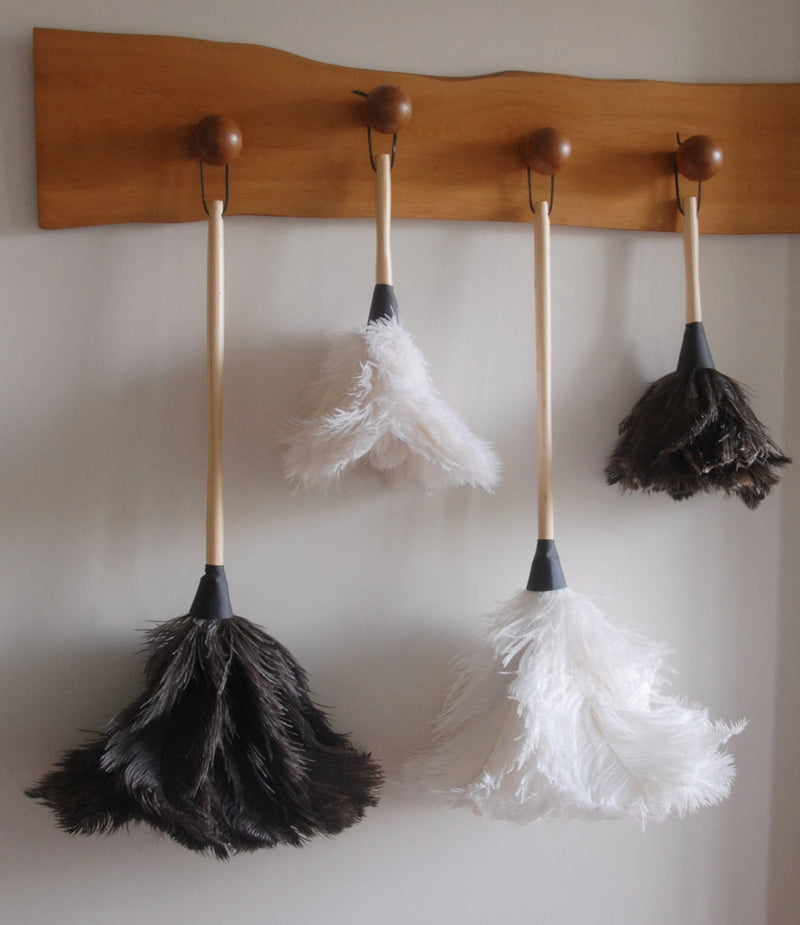 Earth & Nest | Feather Duster with premium feathers and a blond wood handle, displayed on a wall. Ideal for elegant and effective home cleaning.