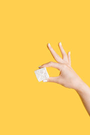 Hand holding a Honey Vanilla Mallow, showcasing its texture; a gourmet marshmallow perfect for toasting, cocoa topping, or snacking from Athens Cooks.