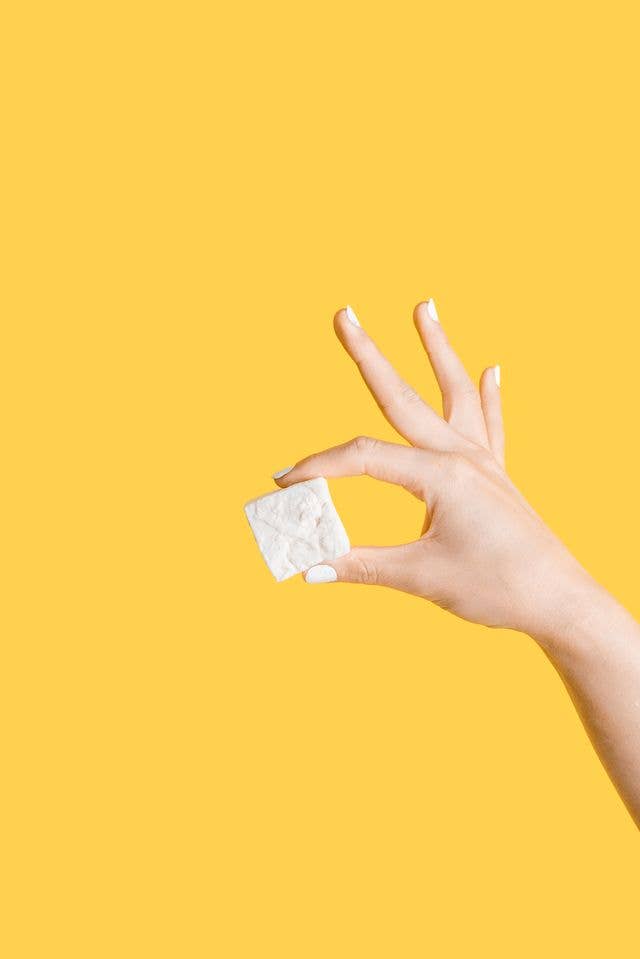 Hand holding a Honey Vanilla Mallow, showcasing its texture; a gourmet marshmallow perfect for toasting, cocoa topping, or snacking from Athens Cooks.