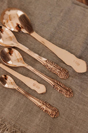 Coppermill Kitchen LLC - Vintage Inspired Measuring Spoon Set features ornate, rose-gold copper spoons with embossed handles, enhancing your kitchen's charm and functionality.