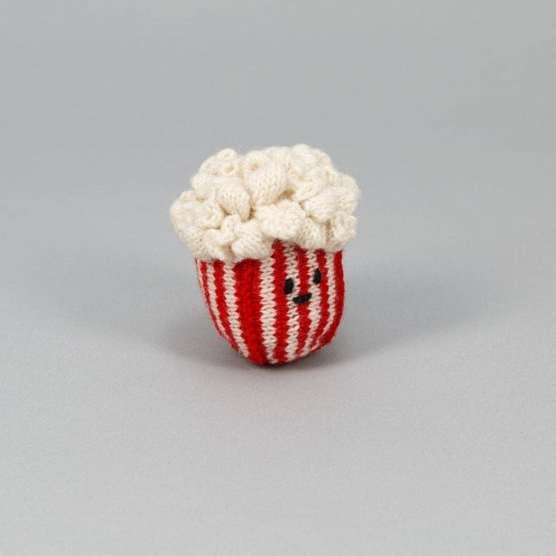 Ware of the Dog - Hand Knit Pop Corn Dog Toy, crafted from 100% lambswool with natural dyes, features a smiling plush popcorn tub design.