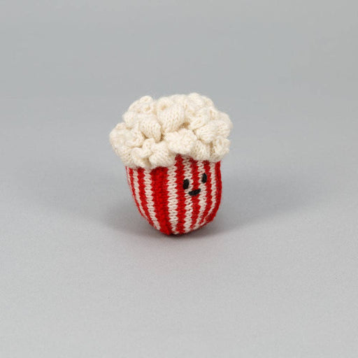 Ware of the Dog - Hand Knit Pop Corn Dog Toy, crafted from 100% lambswool with natural dyes, features a smiling plush popcorn tub design.