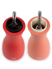 Peugeot | Tahiti Duo Salt + Pepper Mills, Fire, showcasing exposed grinding mechanisms, with one mill in deep red and the other in soft peach, ideal for culinary elegance.
