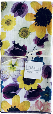 Tisch New York Floral Tea Towel close-up, featuring intricate flower patterns and a care tag, sold individually, 17x25, pre-washed, made in USA, suitable for kitchen use.
