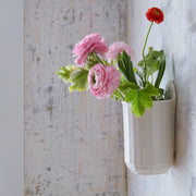 Sir|Madam | Fluted Wall Crock showcases pink and red ranunculus in a rustic, wall-mounted ceramic vase, reflecting Athens Cooks' curated kitchen aesthetic.