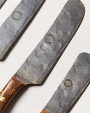 Farmhouse Pottery | Artisan Forged Cheese Knives featuring hammered-steel blades with wreath motifs and smooth wooden handles, perfect for rustic kitchen settings from Athens Cooks.