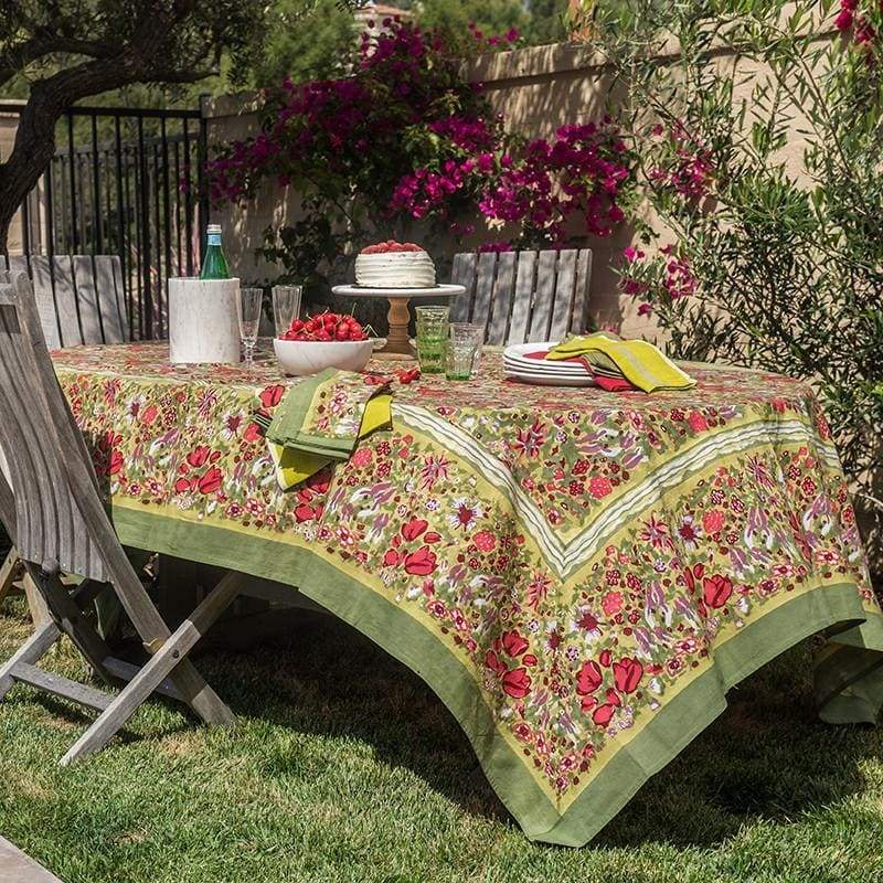 Caravan Home | 59 x 86 Red & Green Tablecloth on a garden table with plates and a bowl of cherries, evoking Southern France's lush, vibrant gardens.