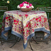 Caravan Home 71 x 106 Red & Grey Tablecloth on a table with a bowl of pink and white flowers, showcasing artisan craftsmanship from the Jardin collection.