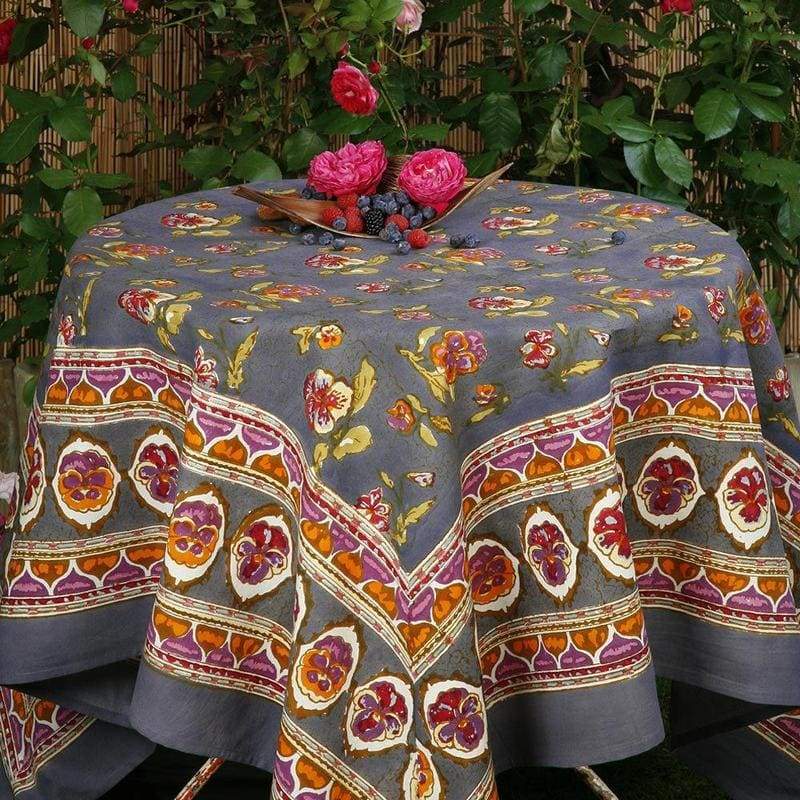 Caravan Home 59 x 86 Pansy Red & Grey Tablecloth featuring intricate floral patterns, elegantly displayed on a set table with decorative elements.