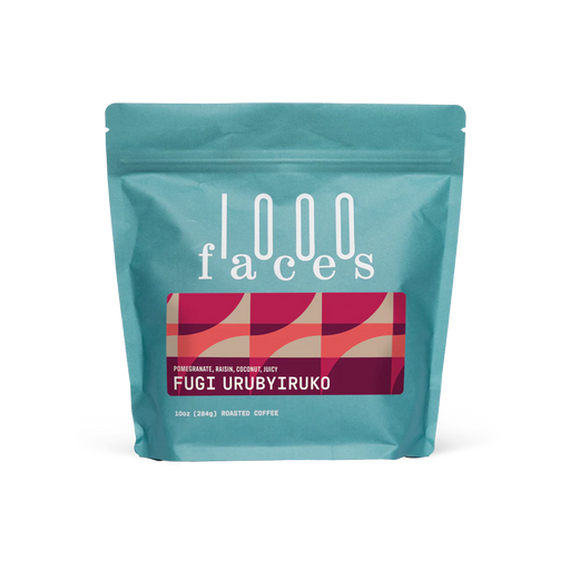 1000 Faces Coffee | Fugi Urubyiruko, 10 oz stand-up pouch showcasing roasted coffee with pomegranate, raisin, and coconut notes, ideal for specialty food enthusiasts.