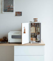 Yamazaki Home | Bread Box, Vertical, Steel + Wood, shown open with bread, drinks, and pantry items inside, next to a toaster-oven on a minimalist kitchen counter.