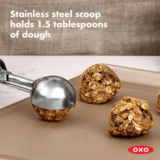 OXO Cookie Scoops - Large, featuring a stainless steel scoop with a spring-loaded handle and soft, non-slip grips for effortless dough portioning and release. Ideal for uniform cookies.