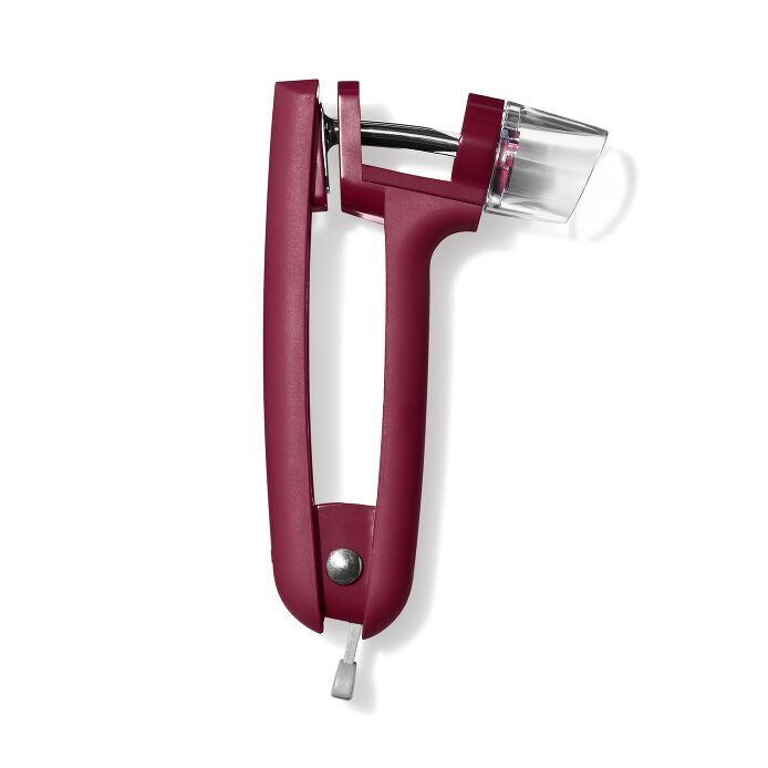 OXO Good Grips Cherry & Olive Pitter in Beet, featuring a red plastic tool with a clear tube, designed for easy and mess-free pitting of fruits.