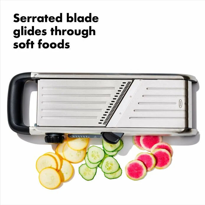 OXO Chef's Steel Mandoline showcasing slices of lemon, apple, and watermelon, highlighting its precision slicing capabilities for fruits and vegetables.