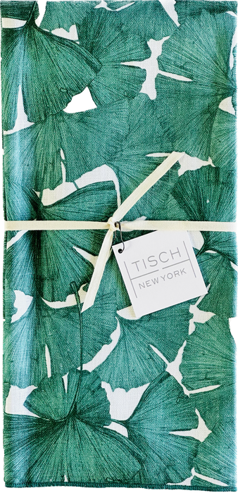 Tisch New York Floral Tea Towel with a white tag on green and white fabric, showcasing intricate detailing. Sold individually, pre-washed, and made in the USA.