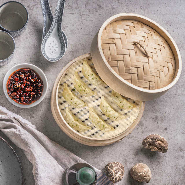 Helen's Asian Kitchen Silicone Steamer Liners in a metal steamer, highlighting their reusable, nonstick design for clean, efficient steaming of various foods.