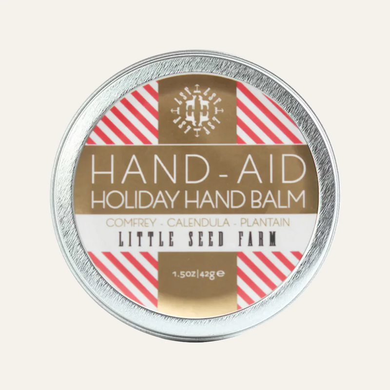 Little Seed Farm | Holiday Hand-Aid: A 1.5 oz tin of soothing hand balm with scents of peppermint bark and sugar cookies, perfect for hardworking hands.