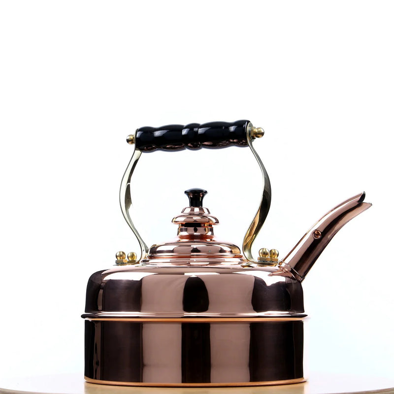 Simplex | Kensington No. 1 Traditional Tea Kettle with a black handle, showcased on a table, highlighting its elegant copper design.