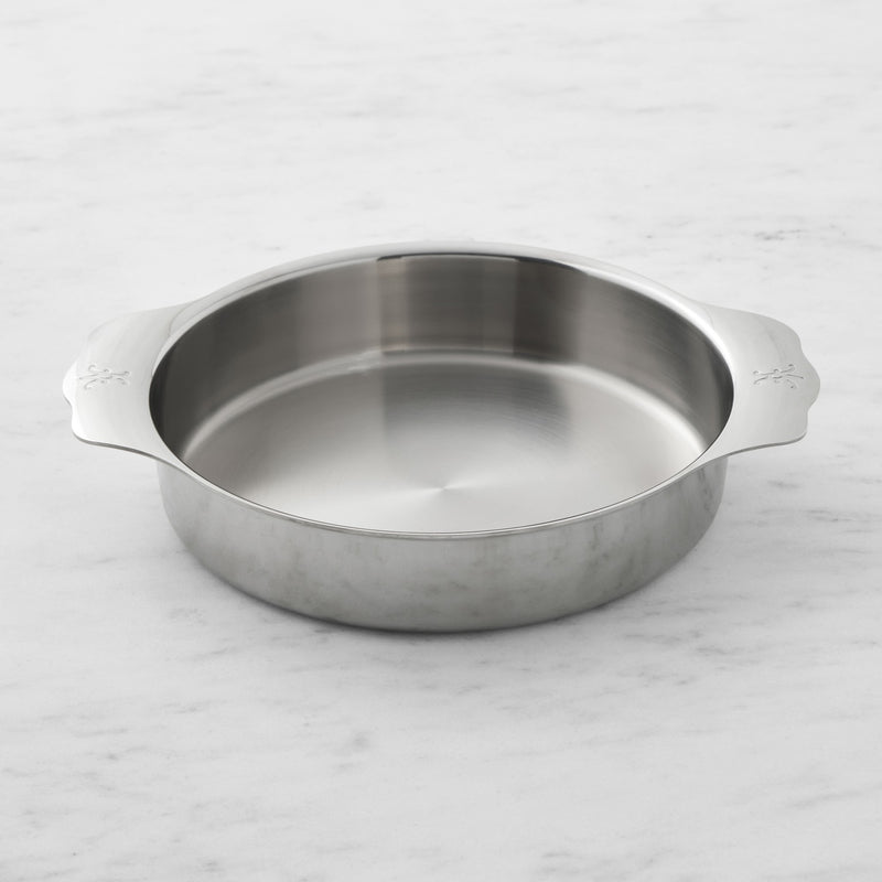 Hestan | OvenBond Round Baker 9 showcased on marble, featuring silver finish and handles, ideal for versatile baking needs at Athens Cooks kitchen store.