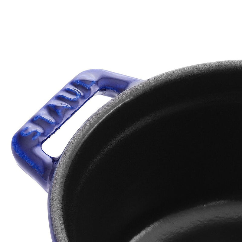 Staub | Mini Round Dutch Oven, Dark Blue, 0.25 QT., showcasing its blue enameled side handle and dark cast-iron interior, perfect for single-serve creations.