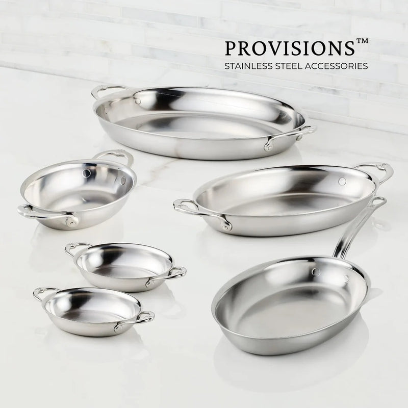 Hestan Provisions | Chef's Special Oval Clad Au Gratin dishes with loop handles, part of a stainless-steel collection, displayed on a countertop.