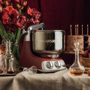 Ankarsrum | Stand Mixers, Black Diamond, showcased with a metal bowl on a festive table with a cake, amaryllis, and decanters, embodying culinary elegance.