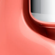 Close-up of a coral Apple Watch case, showcasing its sleek aluminum curve around the sensor, reflecting the precision of Ankarsrum stand mixers at Athens Cooks.