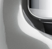 Close-up of the Ankarsrum Stand Mixer, showcasing its sleek metal design near a recessed handle, highlighting its robust, durable craftsmanship for serious home bakers.