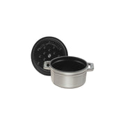 Staub | Mini Round Dutch Oven, Graphite, 0.275 QT. features a matte-gray finish with a self-basting lid, perfect for single-serve culinary creations.