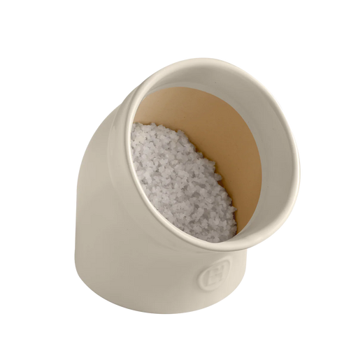 Emile Henry | The Salt Pig, an off-white ceramic pot, holds coarse white crystals, showcasing a practical, stylish design to keep salt accessible and free-flowing.