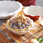 Emile Henry | Modern Classics Mini Pie Dish Set of 2, showcasing an unbaked berry galette in a scalloped ceramic dish, ready for the oven.