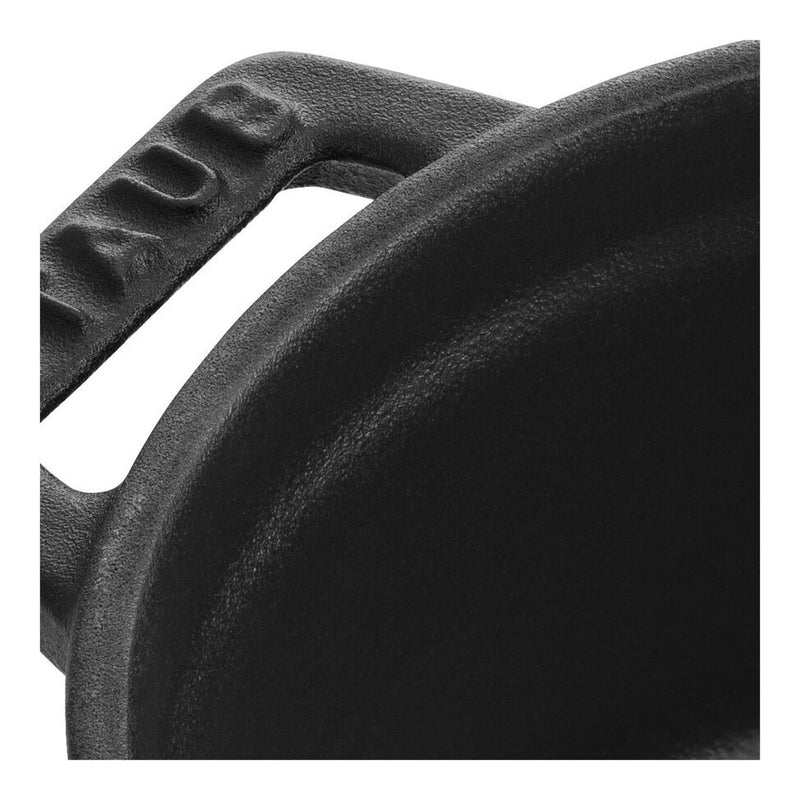 Staub | Mini Round Dutch Oven, Black, 0.275 QT. close-up showing rim and side handle, highlighting enameled cast iron durability and sleek design for single-serve cooking.