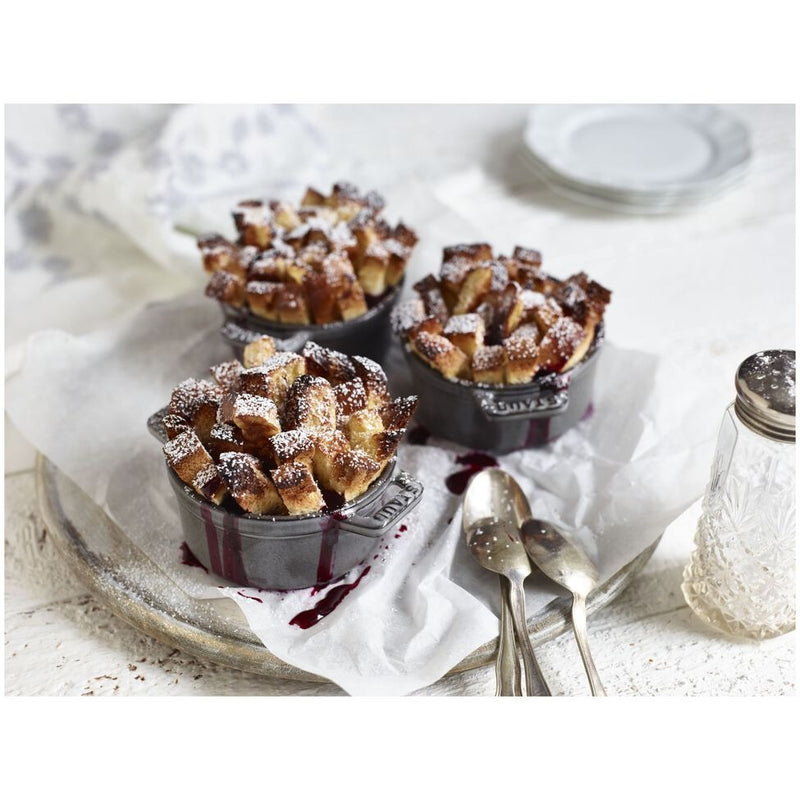 Staub | Mini Round Dutch Oven, Graphite, 0.275 QT filled with golden-brown bread pudding, showcasing its versatility for single-serve culinary creations.