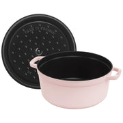 Staub Round Dutch Oven, Pink Peony, 5.5 QT. features a French-made enameled cast-iron design with a matching lid, perfect for versatile cooking.