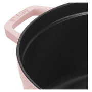 Staub | Round Dutch Oven, Pink Peony, 5.5 QT., close-up of handle with maker’s name and black matte enamel interior, ideal for diverse culinary tasks.