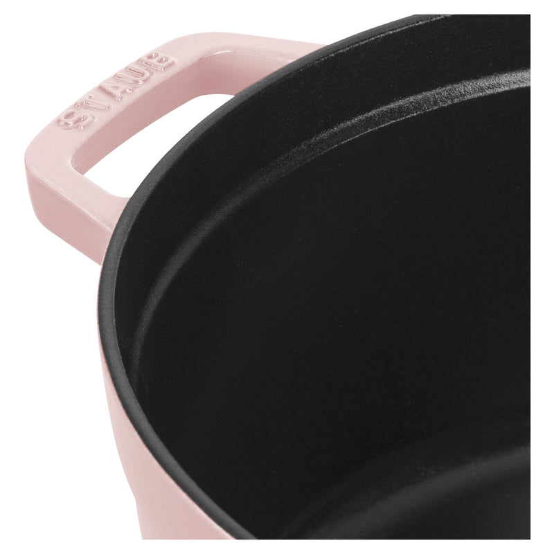 Staub | Round Dutch Oven, Pink Peony, 5.5 QT., close-up of handle with maker’s name and black matte enamel interior, ideal for diverse culinary tasks.