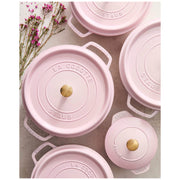 Staub | Round Dutch Oven, Pink Peony, 5.5 QT, with La Cocotte and Staub embossed lids, surrounded by small pink flowers, showcasing elegant cookware.