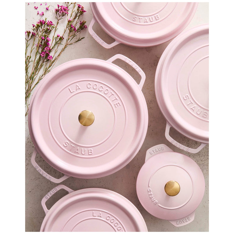 Staub | Round Dutch Oven, Pink Peony, 5.5 QT, with La Cocotte and Staub embossed lids, surrounded by small pink flowers, showcasing elegant cookware.
