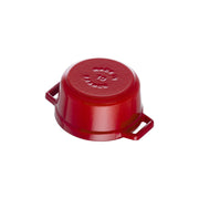 Staub | Mini Round Dutch Oven, Cherry, 0.275 QT., shown upside-down, revealing Made in France stamp and side handles, ideal for slow cooking and braising.