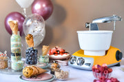 Ankarsrum | Stand Mixers at a dessert station with waffle cones, toppings, and balloons, exemplifying its versatility for creating ice cream or frozen yogurt.