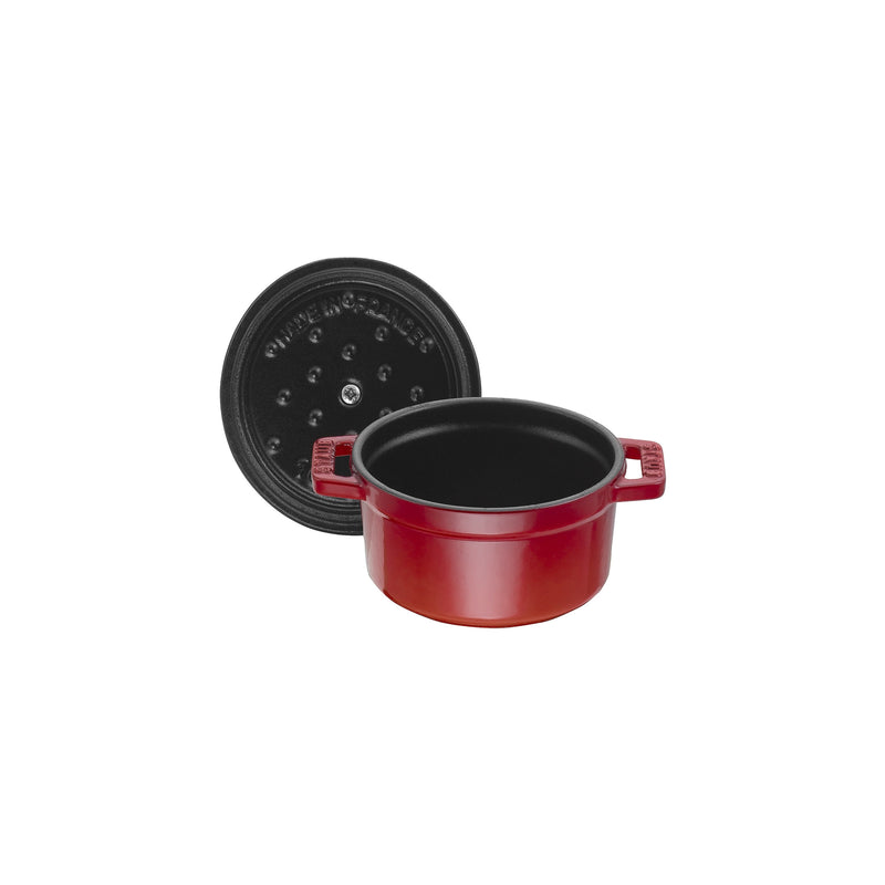 Staub | Mini Round Dutch Oven, Cherry, 0.275 QT, features a red enameled cast-iron pot with side handles and a black lid designed for self-basting.