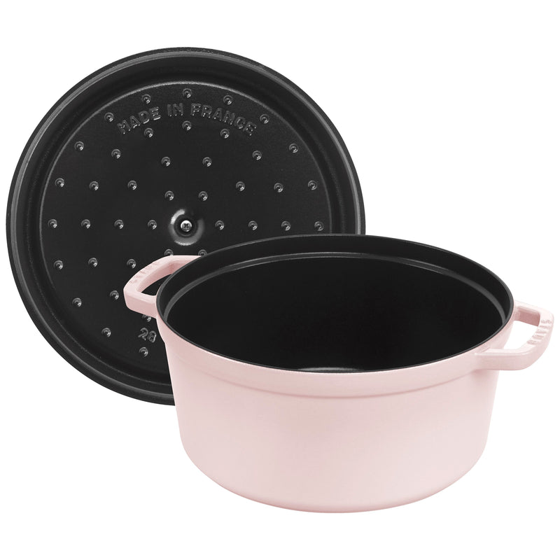Staub | Round Dutch Oven, Pink Peony, 7 QT: A round, pink enameled cast-iron casserole with a black lid featuring Made in France and self-basting dimples.