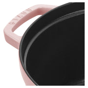 Staub | Round Dutch Oven, Pink Peony, 7 QT, featuring a pink exterior with Staub on the handle, and a black, matte-textured cooking surface.