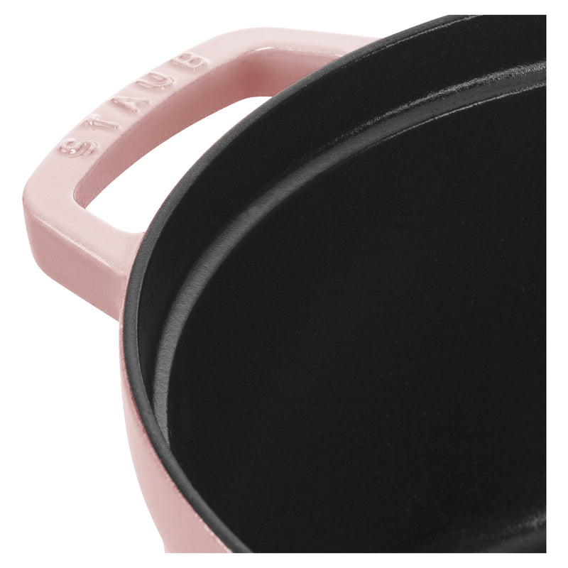Staub | Round Dutch Oven, Pink Peony, 7 QT, featuring a pink exterior with Staub on the handle, and a black, matte-textured cooking surface.