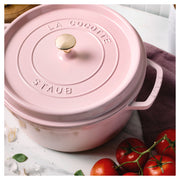 Staub | Round Dutch Oven, Pink Peony, 7 QT on marble with tomatoes, garlic, and basil, embodying Athens Cooks' curated kitchen essentials.