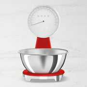 Smeg | Kitchen Scale with retro-modern style, featuring dual-mode analog and digital dial, stainless-steel bowl, and USB charging, ideal for precise kitchen measuring.