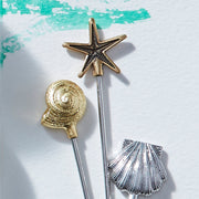 Joanna Buchanan | Cocktail Picks - Shell: Set of six elegant shell-design picks atop stainless steel and zinc, ideal for martinis or appetizers.